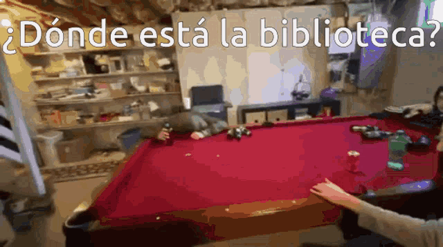 a pool table with the words " donde esta la biblioteca " written on it