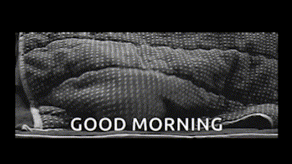 a black and white photo of a person laying under a blanket with the words good morning written on it