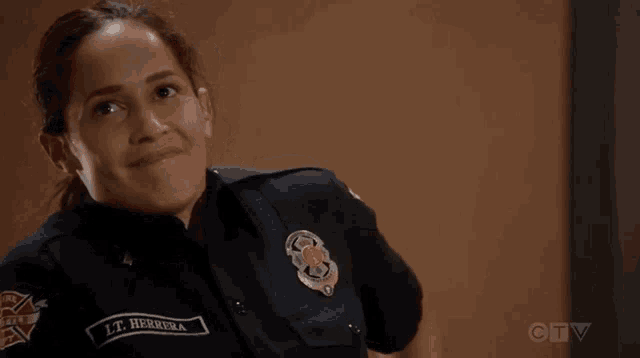 a woman in a police uniform with the name lt herrera