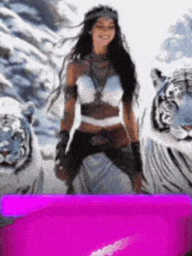 a woman standing next to two white tigers