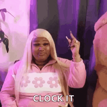 a woman in a pink jacket is holding a cigarette in her hand and says clock it .