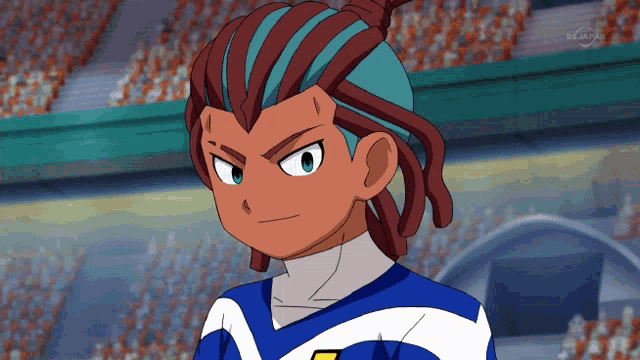 a boy with dreadlocks and a blue and white shirt is on a tv screen