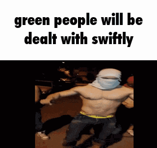 a shirtless man with a bandana on his head is dancing in front of a group of people .