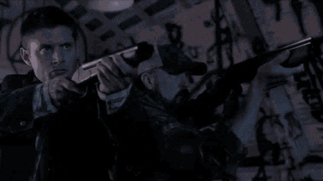 a man in a plaid shirt is holding a gun