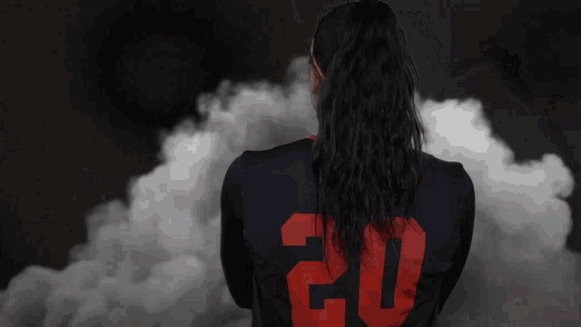 a woman wearing a jersey with the number 20 on the back