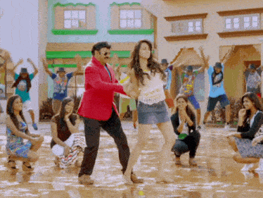 a man and woman are dancing in front of a crowd
