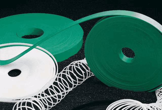 green and white spools of wire on a table