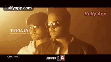 two men wearing sunglasses are standing next to each other in front of a screen that says kulfy app