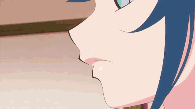 a woman with blue hair is eating a green item