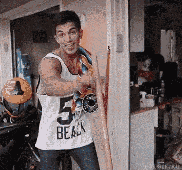 a man wearing a tank top that says beach is holding a skateboard