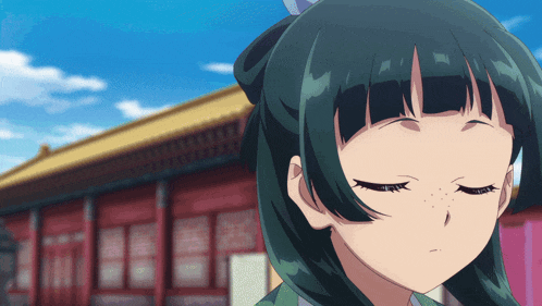 a girl with green hair is looking down with her eyes closed