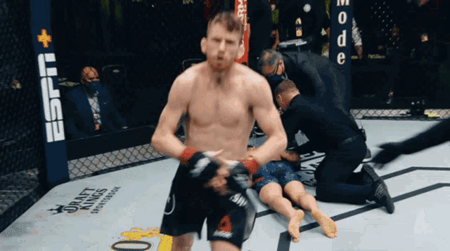 a man in a boxing ring with the word espn on the wall