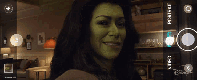 a woman with a green face is taking a portrait with disney +