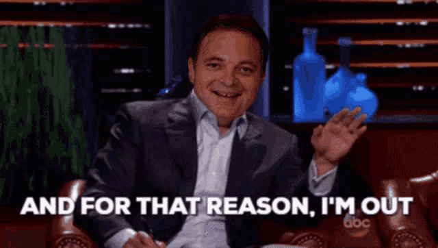 a man in a suit says " and for that reason i 'm out " while sitting in a chair