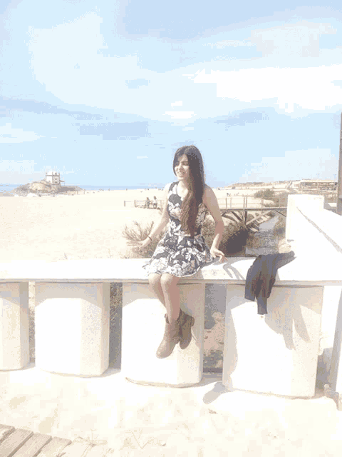 a woman sits on a white bench covering her mouth