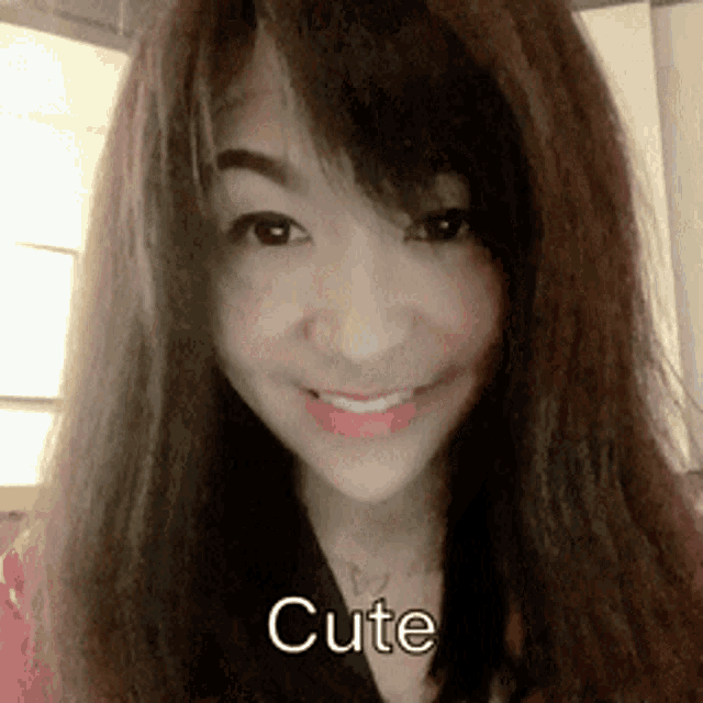 a close up of a woman 's face with the words cute written below her