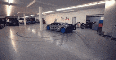 a car in a garage with the word dde on the side