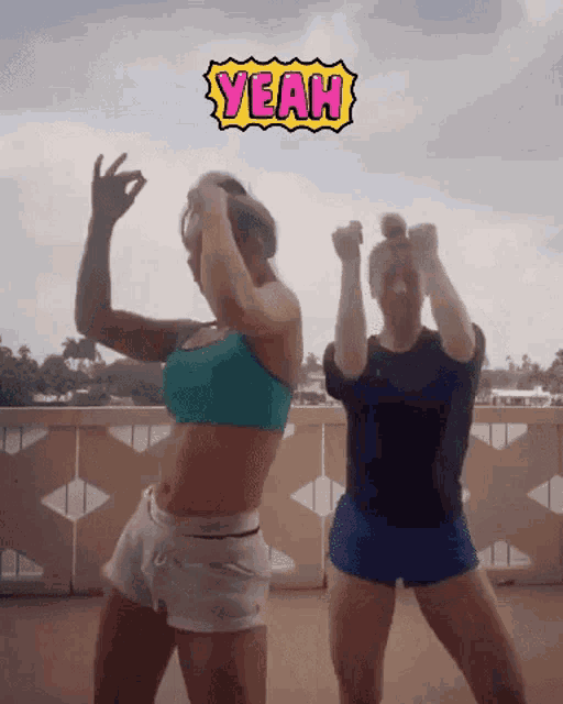two women are dancing with a yeah sign above them