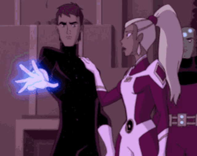 a man and a woman are standing next to each other and the man is holding something in his hand