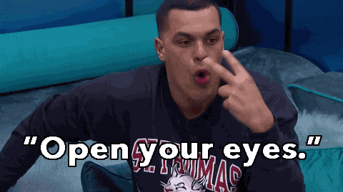a man wearing a sweater that says ' open your eyes '