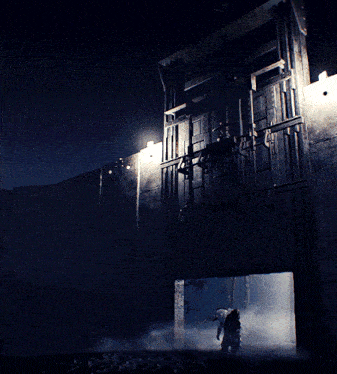 a dark building with a light shining through the doorway