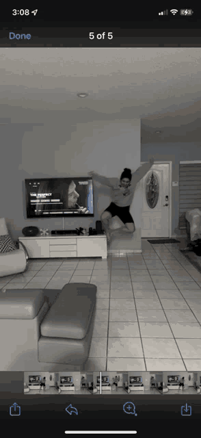 a phone screen shows a picture of a person jumping in the air with the time of 3:08