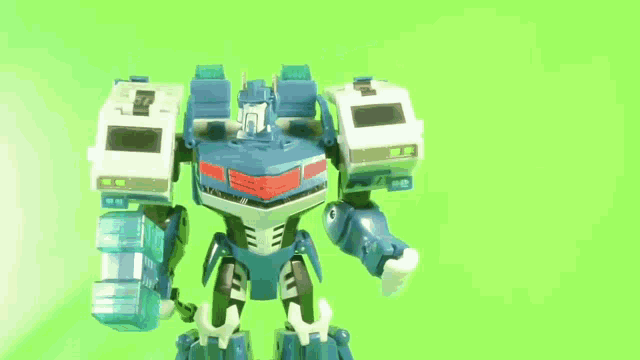 a toy robot with a green screen behind it that says ' a ' on it
