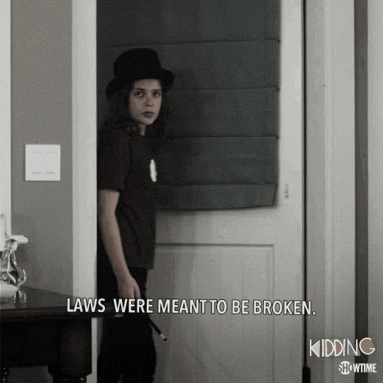 a kid standing in a doorway with the words " laws were meant to be broken " above him