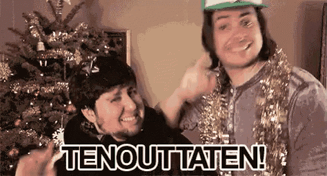 two men are standing next to each other in front of a christmas tree and a sign that says tenouttaten