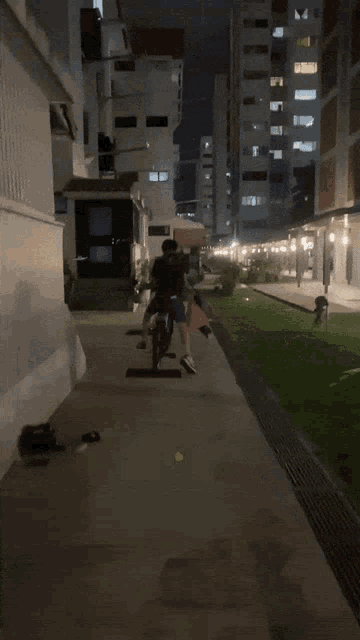 a person is walking down a sidewalk in front of a building