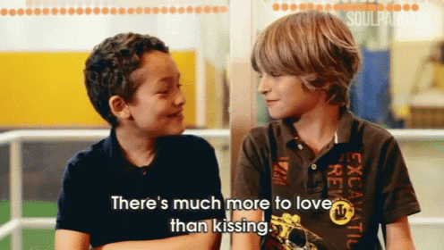 two young boys are sitting next to each other and one of them is saying there 's much more to love than kissing