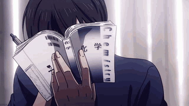 a man is reading a book titled chemistry