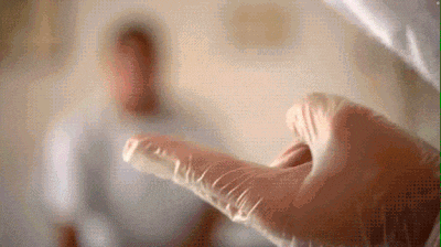a close up of a person 's hand wearing a glove .