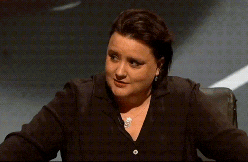 a woman wearing a black shirt and a silver necklace with a pendant that says ' i love you ' on it