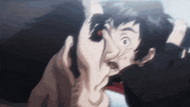 a man is making a funny face while holding another man 's head .