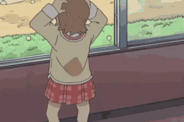 a girl is standing in front of a window with her hands on her head and looking out .