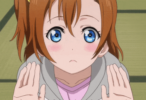 a girl with brown hair and blue eyes is looking at the camera