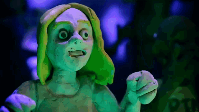 a clay sculpture of a woman with green hair and a purple background