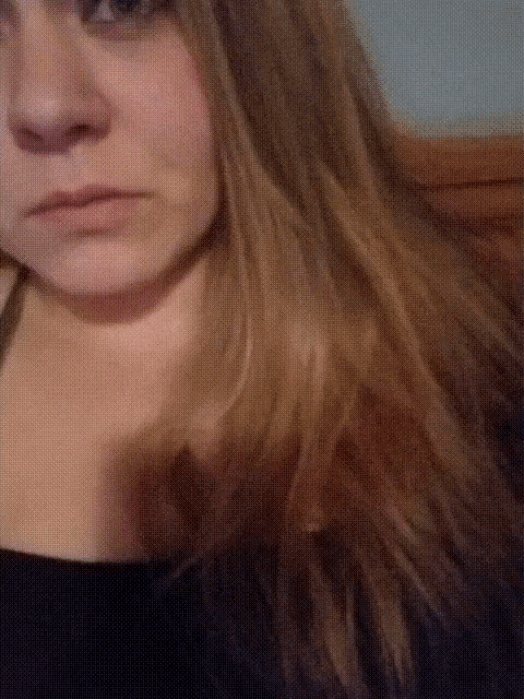 a close up of a woman 's face with a black shirt