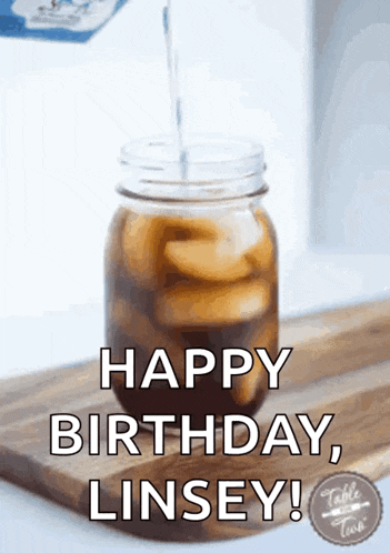 a mason jar of iced coffee with the words happy birthday linsey
