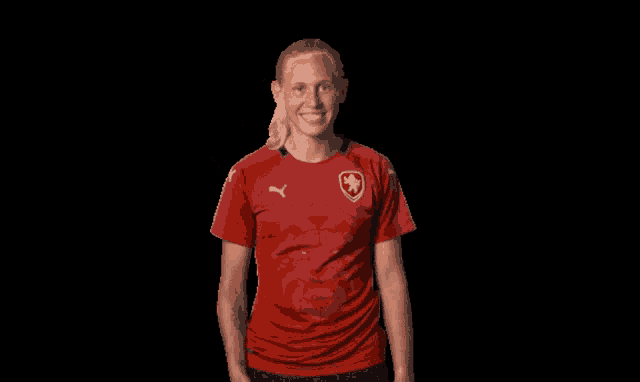 a woman wearing a red shirt with a star on the front