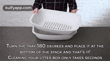 a man is cleaning a litter box with a tray .