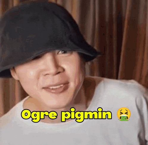 a man wearing a hat and a white shirt says ogre pigmin .