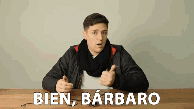 a man with a scarf around his neck is giving a thumbs up and says bien barbaro