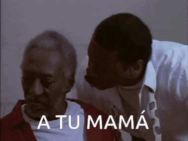 a man kissing an older man 's forehead with the words " a tu mama " written below him