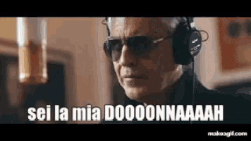 a man wearing headphones and sunglasses is saying `` sei la mia doooonnaaah '' .