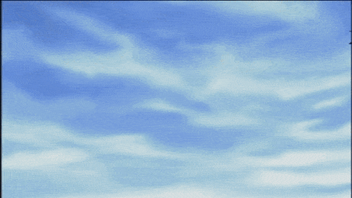a person wearing a mask against a blue sky with clouds