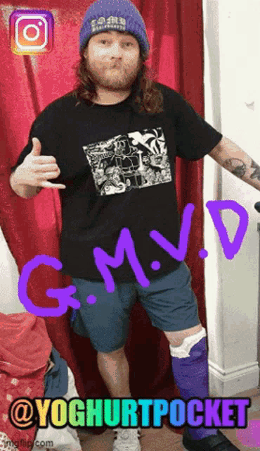 a man with a beard wearing a purple hat and a black shirt with g.m.v.d. written on it