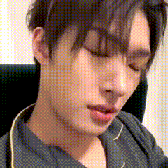 a close up of a young man 's face with his eyes closed .