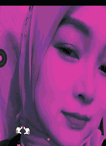 a close up of a woman 's face with a pink heart on her cheek